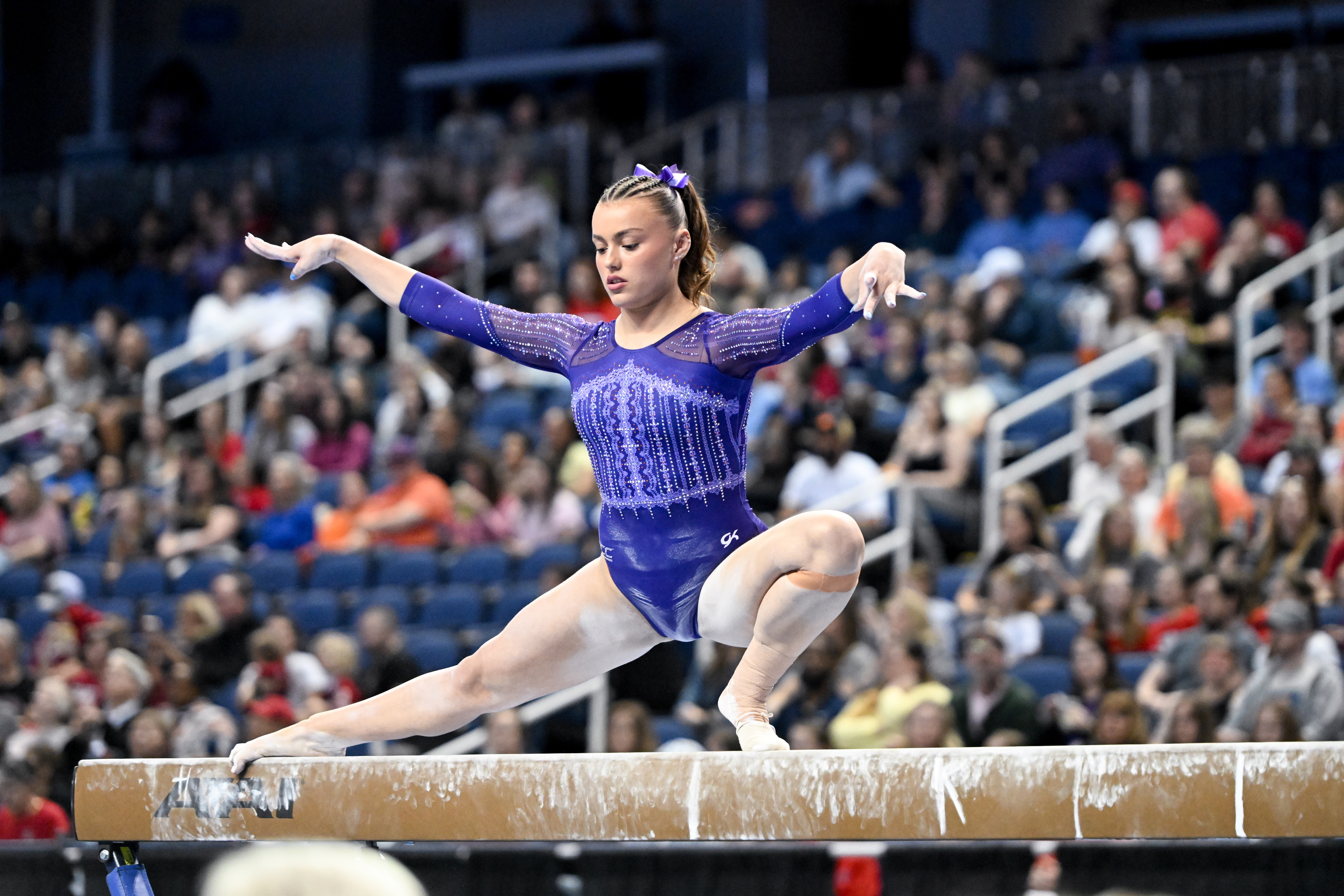 Gymnasts competing on the floor at a Greensboro championship event