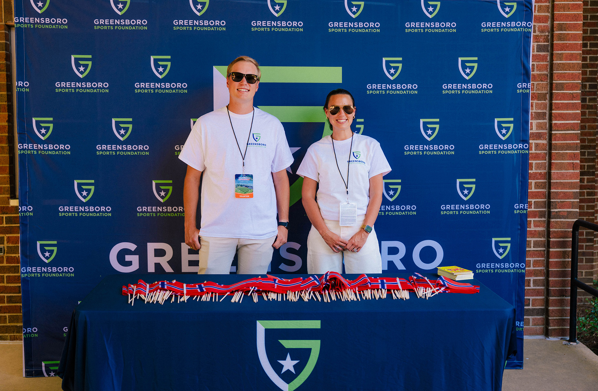 Greensboro Sports Foundation volunteers helping guests at a community sports event