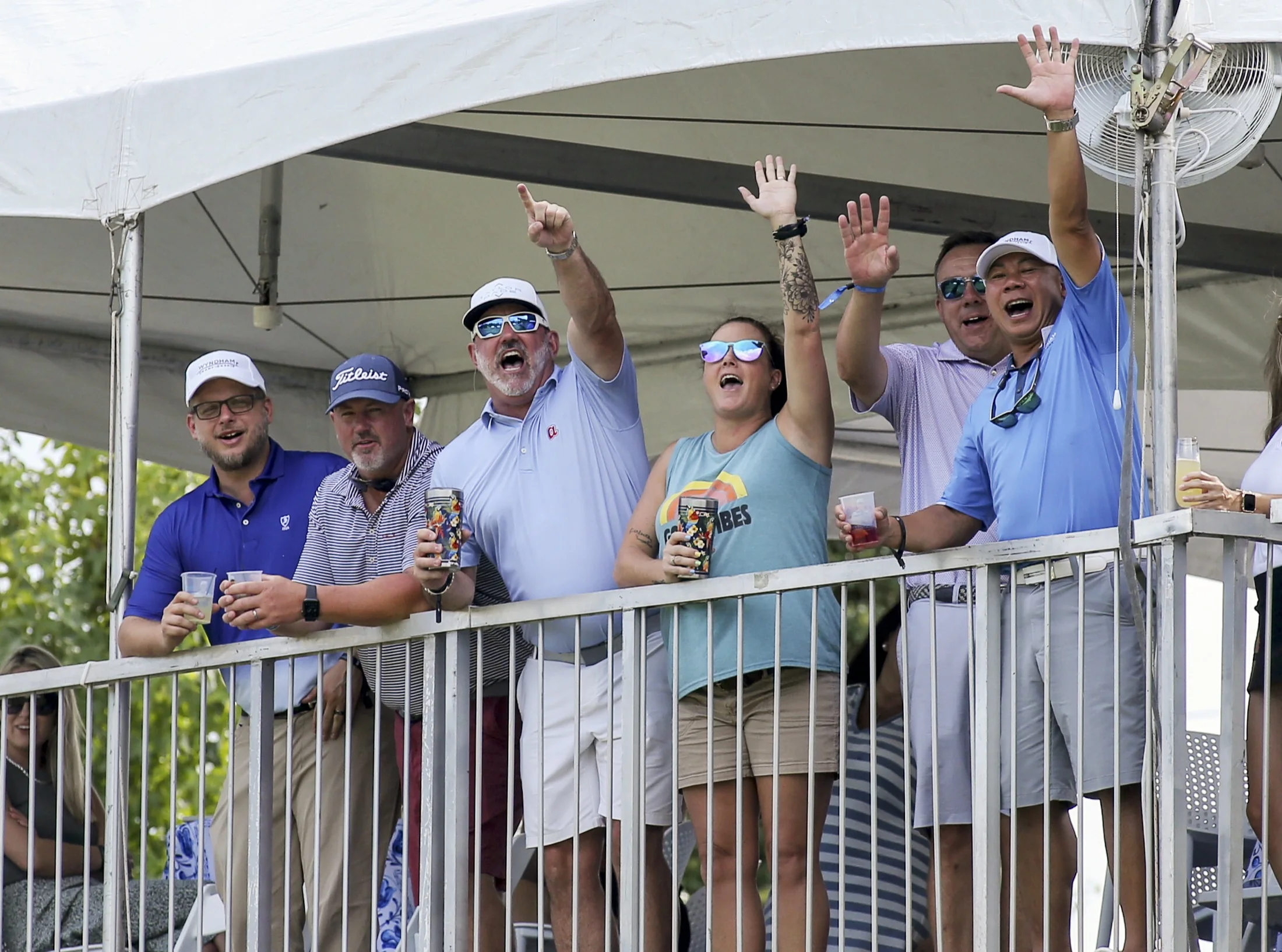 Event supporters cheering from the gallery at a Greensboro championship