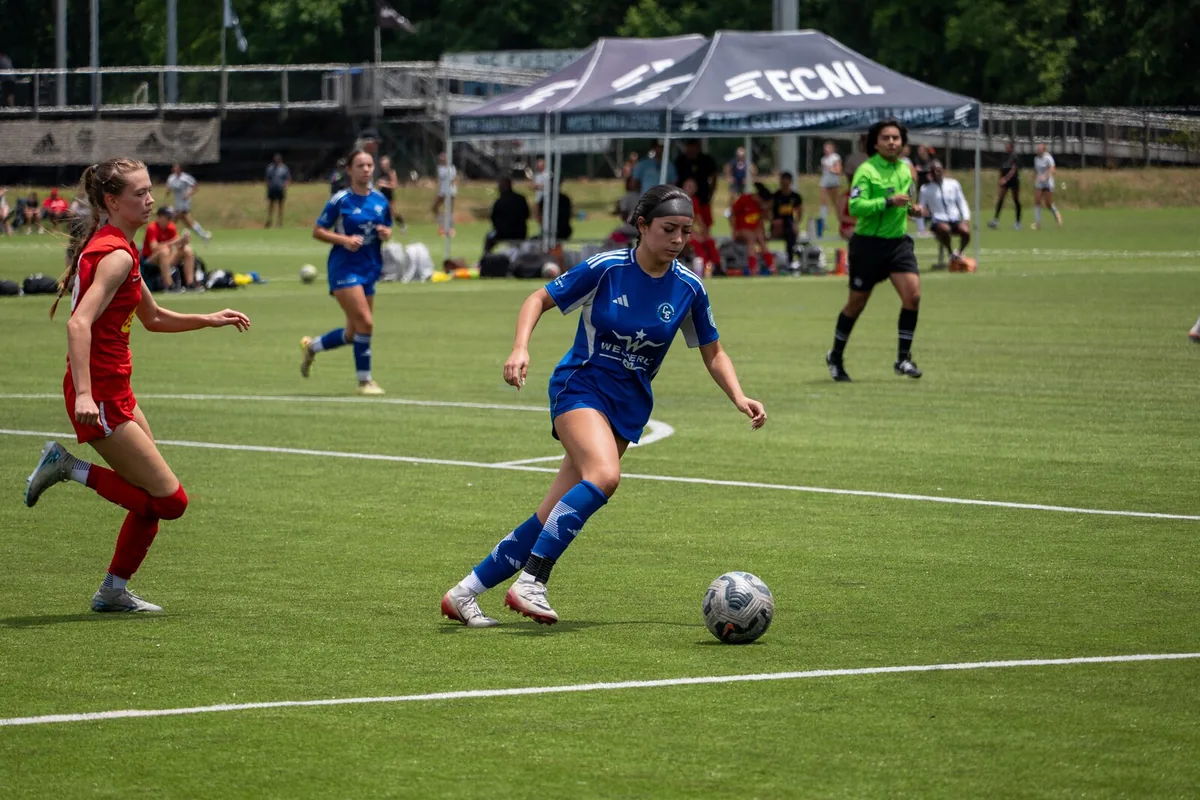 A soccer player dribbles during tournament play in Greensboro