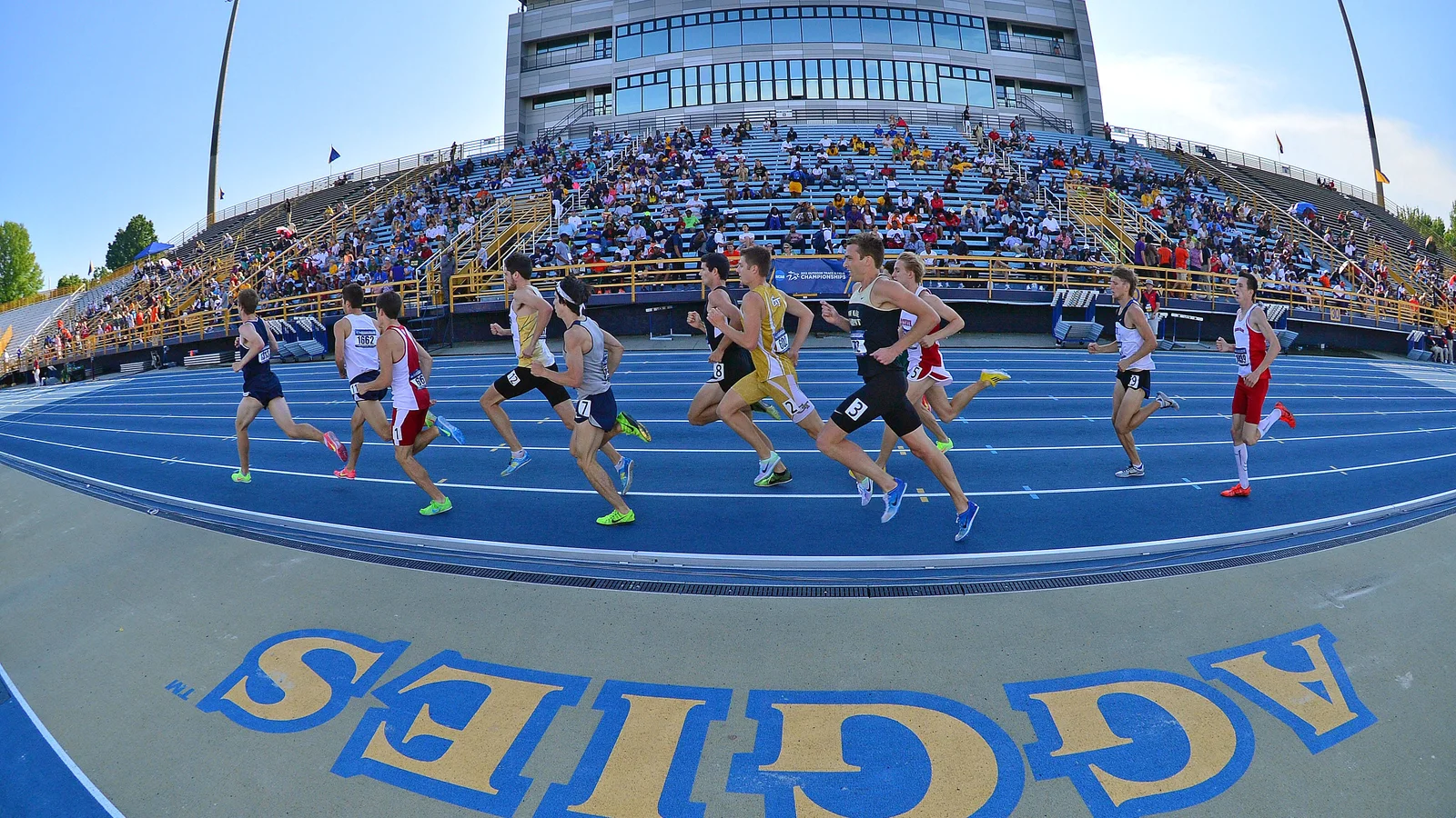 Runners rounding the track in front of the grandstand at North Carolina A&T