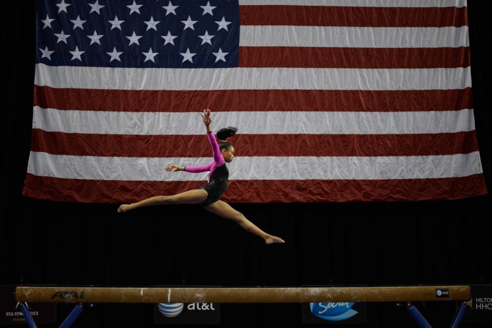 Young gymnast competing at a championship event in Greensboro