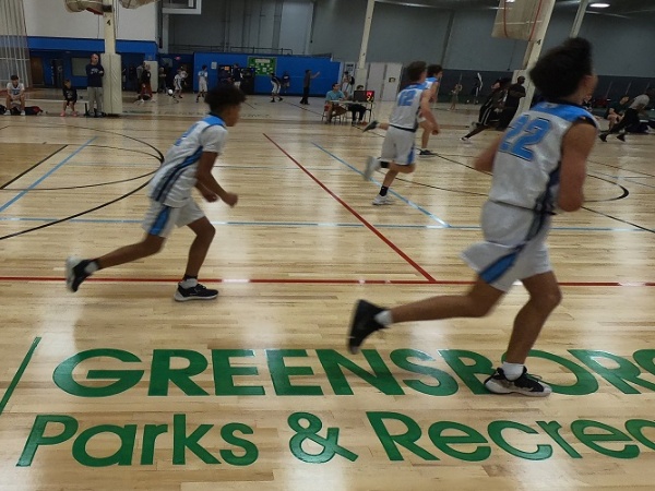 Youth basketball game on a hardwood court at GSO Sportsplex